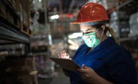 Woman in hard hat with tablet