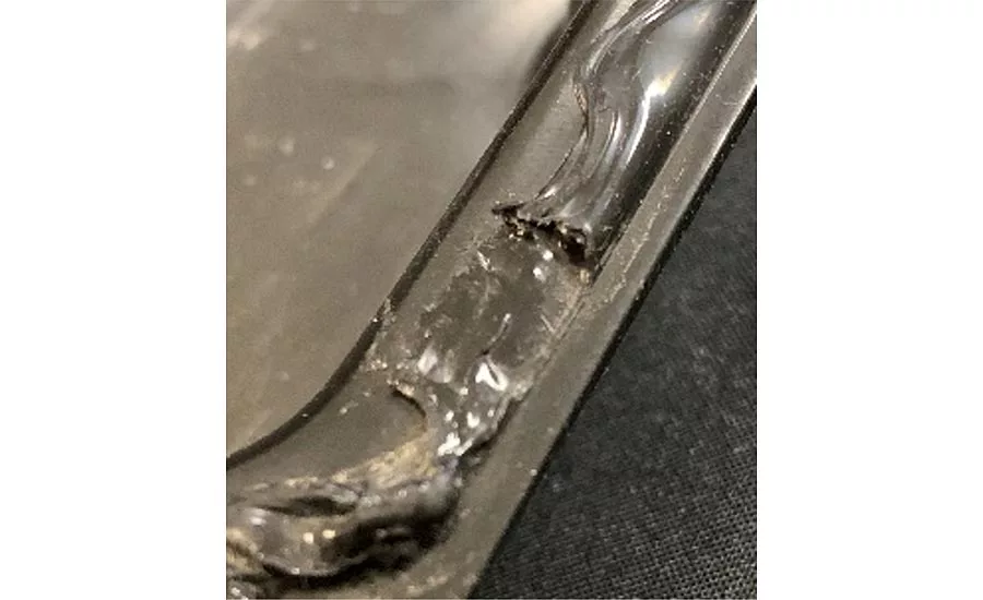 This adhesive bead has a large skip in the specified path and must be repaired.