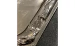 This adhesive bead has a large skip in the specified path and must be repaired.