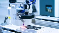 Robot holding glue syringe Injection with robotic machine vision system.