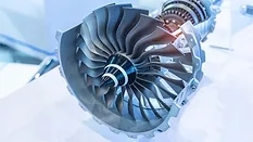 Close-up of a turbine rotor and compressor assembly used in an aircraft engine.