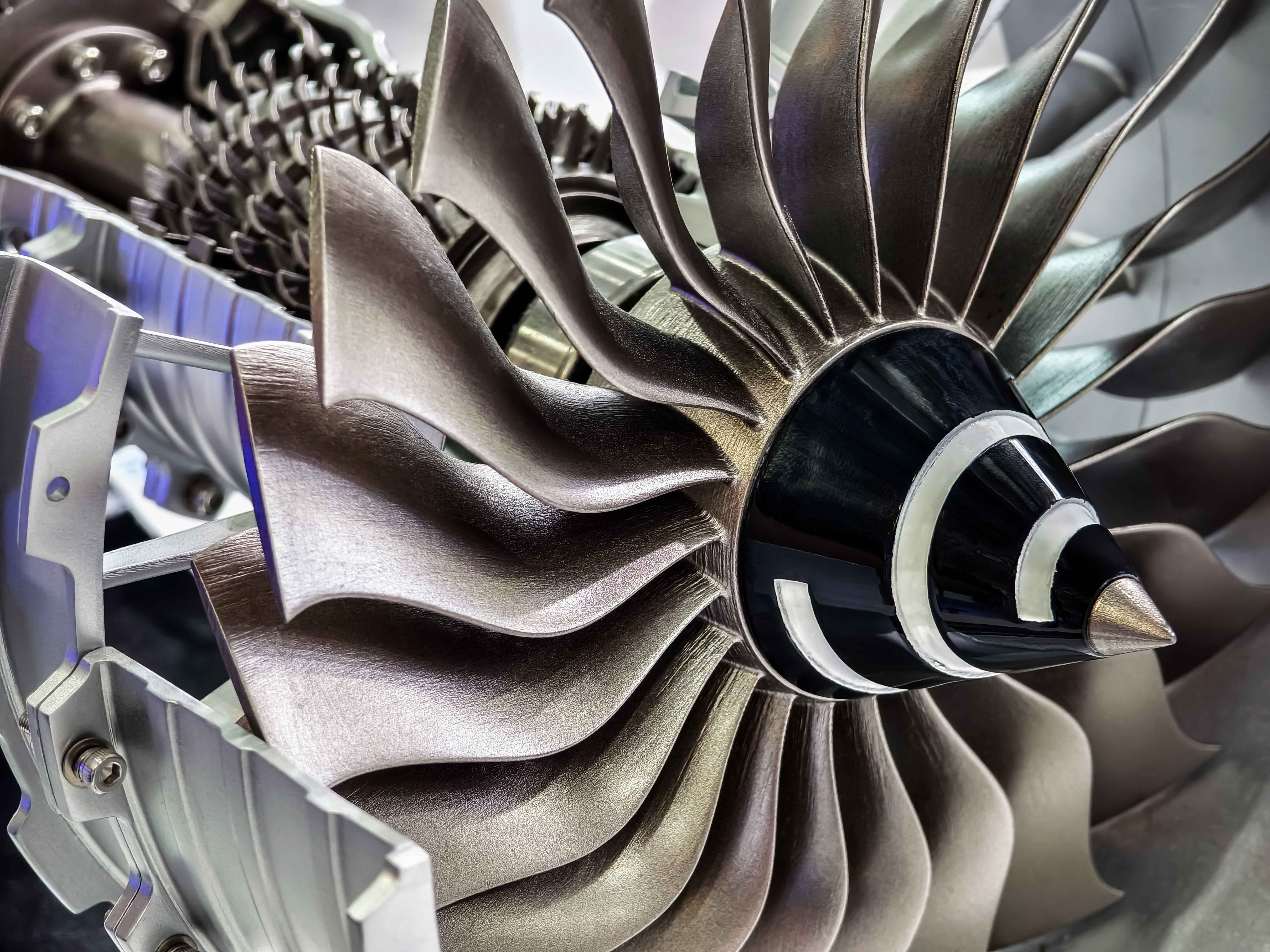 Close-up of a turbine rotor and compressor assembly used in an aircraft engine.