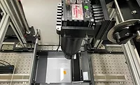 High-Speed Line-Scan Inspection System for Industrial Quality Control Line-scan camera inspection system mounted above a moving sample stage used for high-speed industrial quality control and machine vision applications.