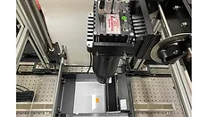 High-Speed Line-Scan Inspection System for Industrial Quality Control Line-scan camera inspection system mounted above a moving sample stage used for high-speed industrial quality control and machine vision applications.