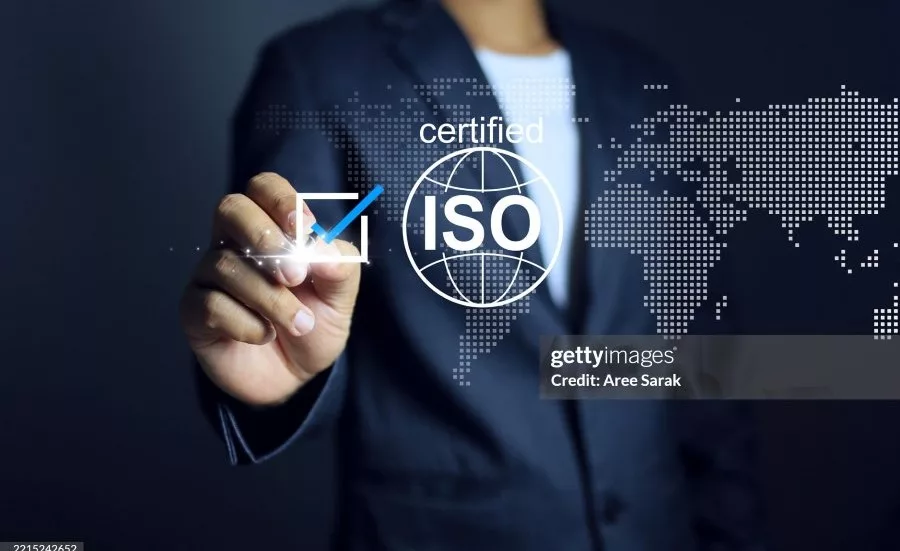 Business professional selecting an ISO certification icon on a digital interface, representing quality management standards, compliance, and international certification programs.