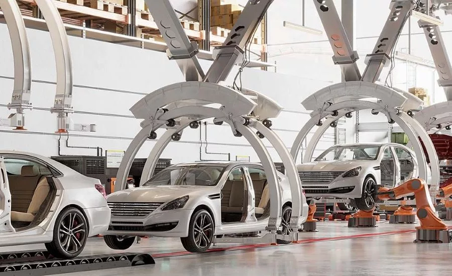 Automated automotive assembly line with robotic systems and vehicle bodies moving through a modern car manufacturing facility.