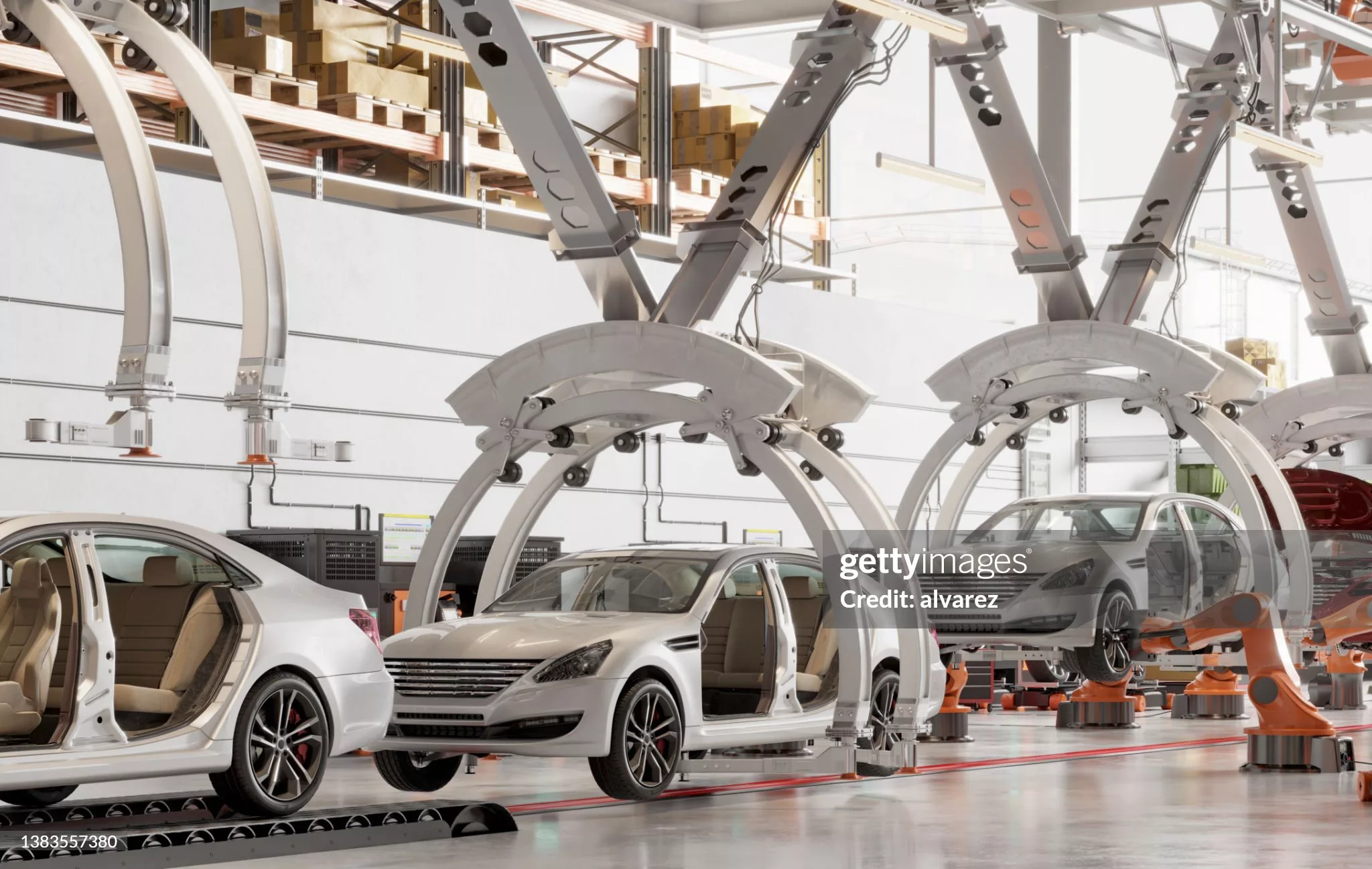 Automated automotive assembly line with robotic systems and vehicle bodies moving through a modern car manufacturing facility.