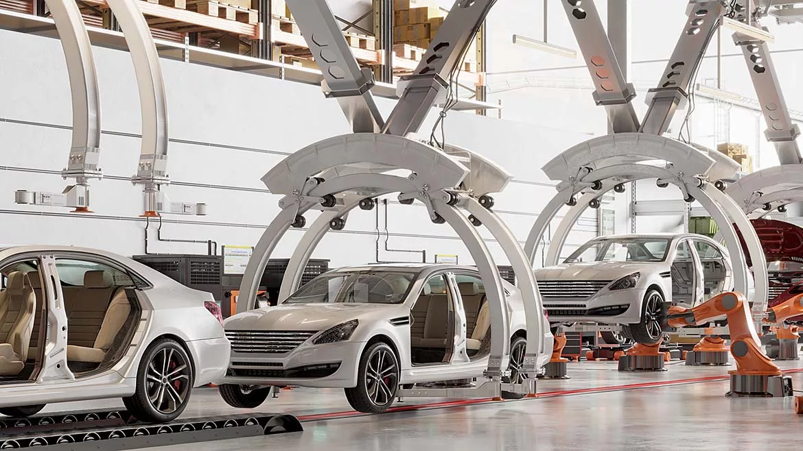Automated automotive assembly line with robotic systems and vehicle bodies moving through a modern car manufacturing facility.