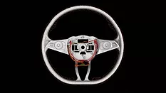 Industrial computed tomography (CT) scan of an automotive steering wheel, revealing internal wiring, electronic components, and structural features for nondestructive inspection and quality analysis.