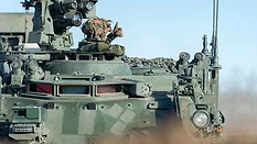 Soldier Operating an Armored Military Vehicle Soldier giving a thumbs-up from the hatch of an armored military vehicle.