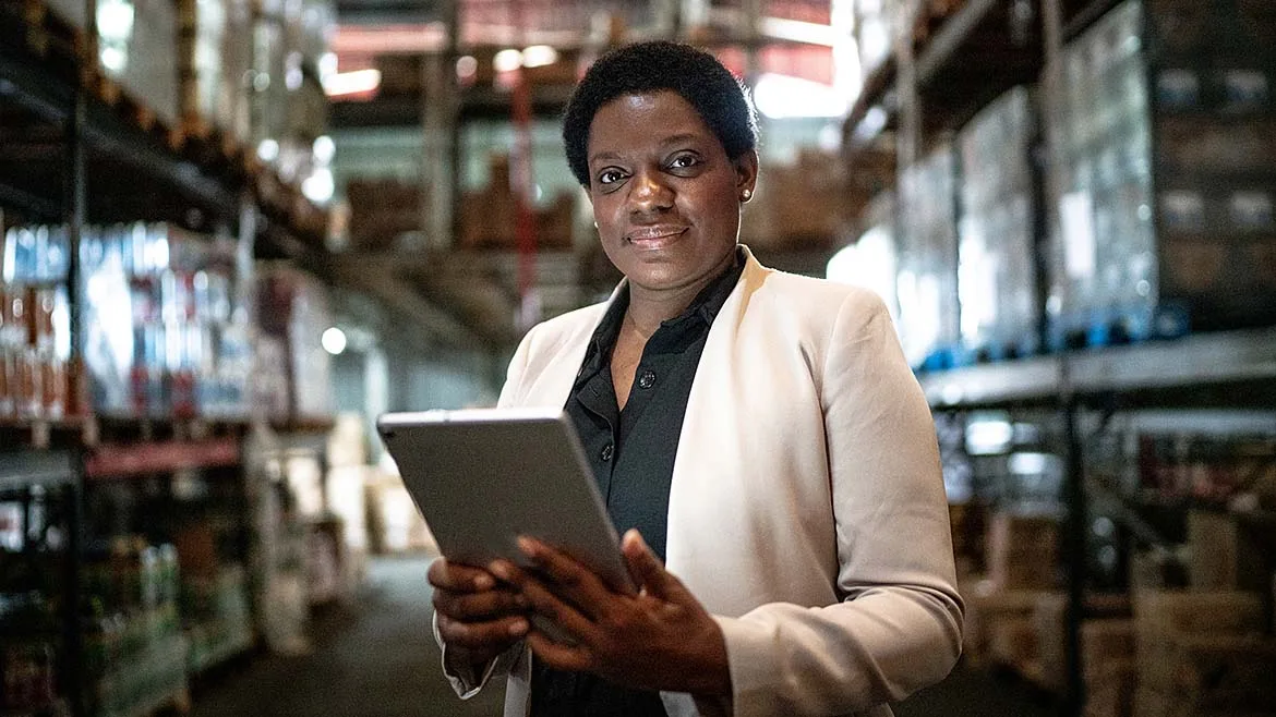 Warehouse manager using a tablet in a distribution center.