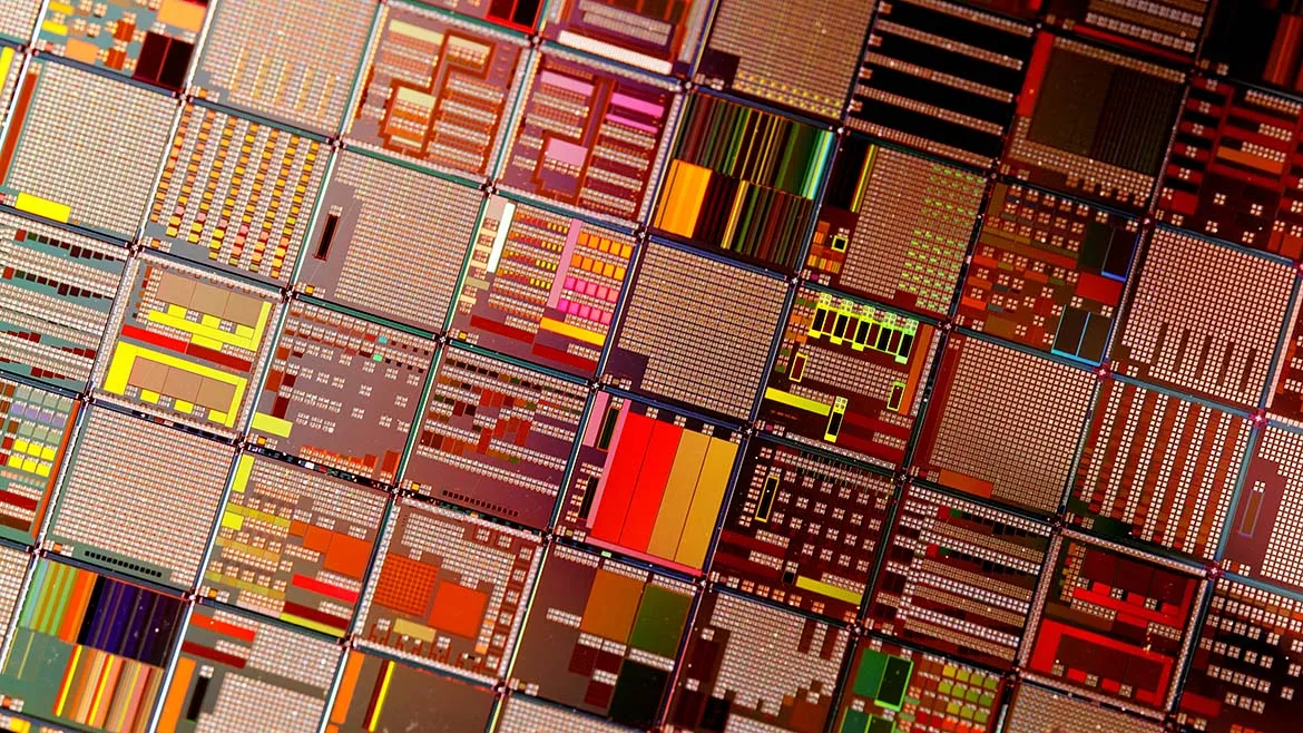 Close-up of semiconductor wafer die patterns on a silicon chip.
