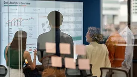 Business team reviewing analytics dashboards during a meeting.