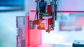 Automated precision dispensing system applying material to manufactured components.