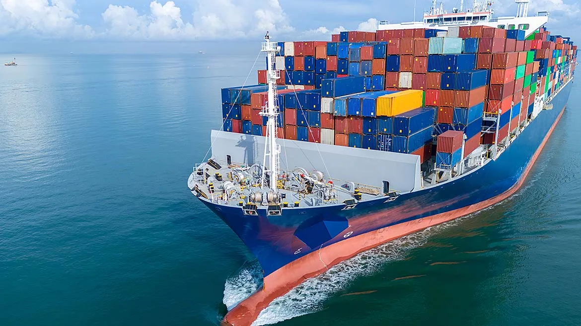 Container Ship Transporting Cargo Container ship carrying stacked shipping containers across open water.