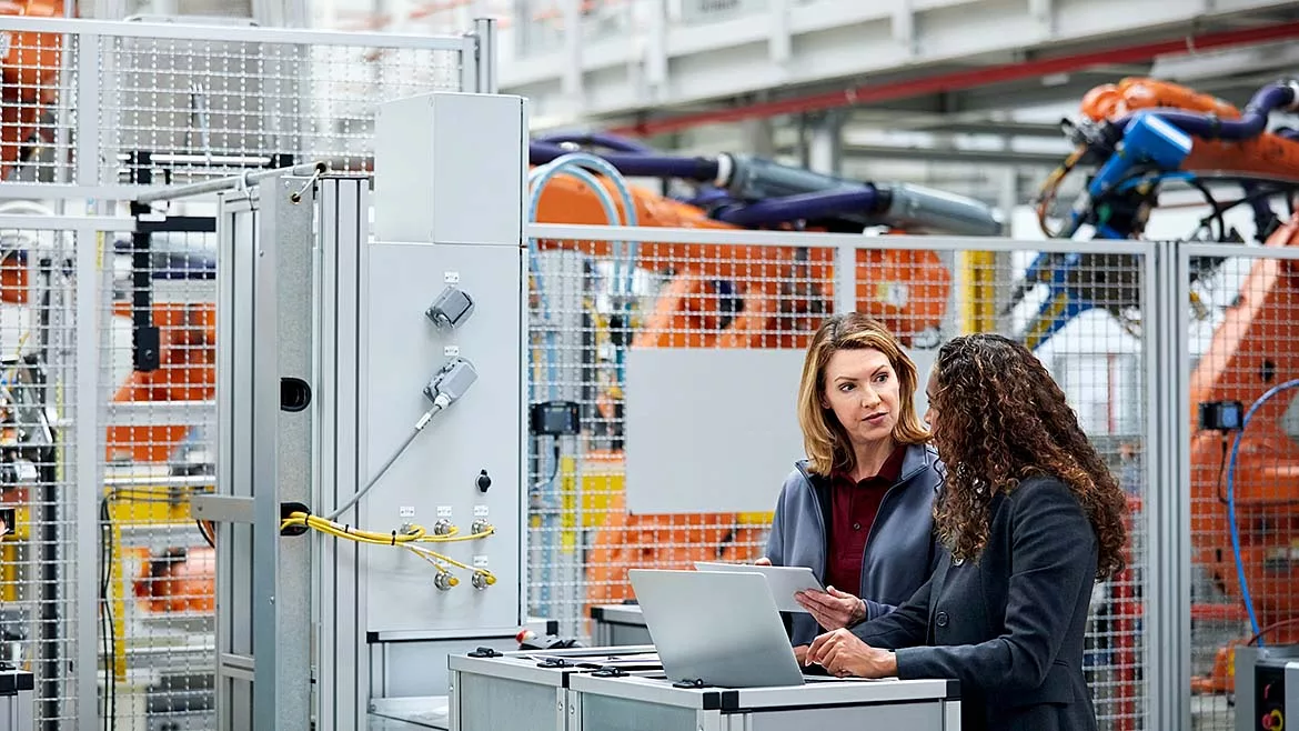 Two people working in a manufacturing facility.