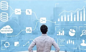 Businessman looking over a large virtual screen of graphic data such as flow charts, bar graphs and pie charts.