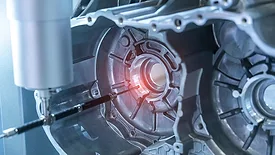 The multi-axis CMM machine measure the aluminum car engine part.