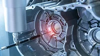 The multi-axis CMM machine measure the aluminum car engine part.