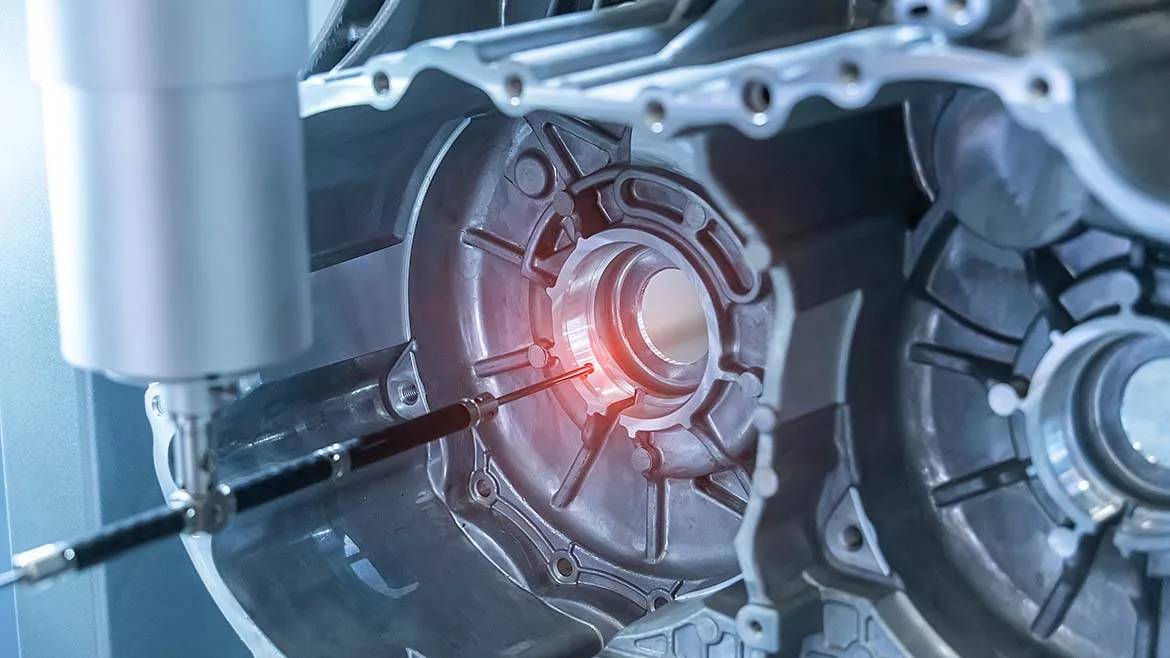The multi-axis CMM machine measure the aluminum car engine part.