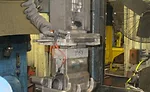 Figure 13: Automated unloading of a casting by a pick-and-place unit.