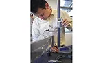 A metrology student works on a surface plate layout inspection of a training part supplied by industry partners.