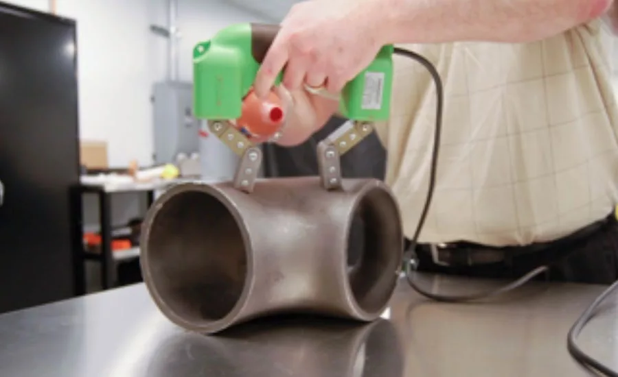 Magnetic particle inspection using an AC magnetic yoke and dry method magnetic particles.