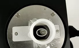 Metal sliver in sample cup, ready for handheld XRF analysis. Source: Bruker