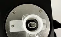 Metal sliver in sample cup, ready for handheld XRF analysis. Source: Bruker