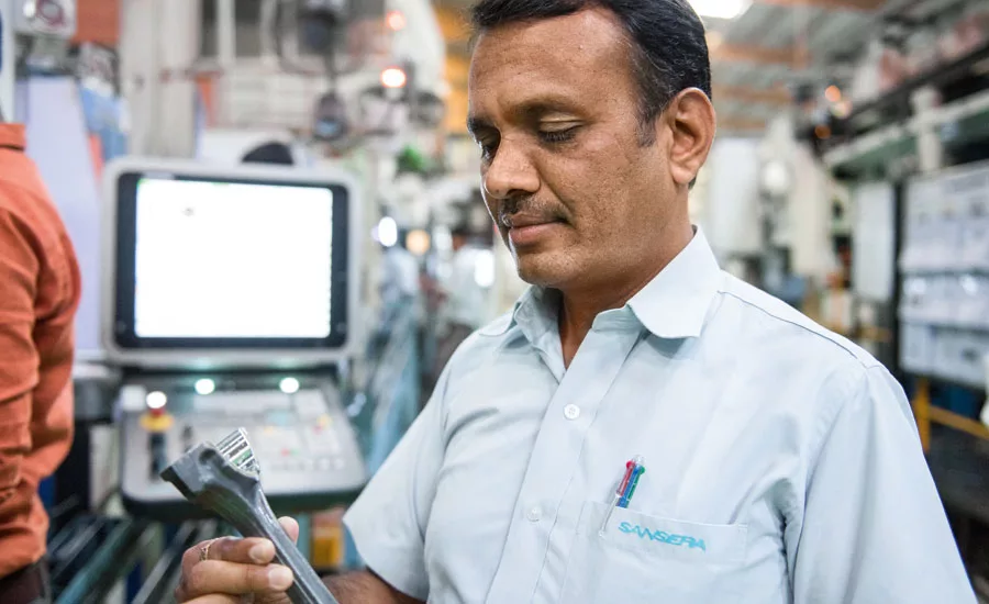 Quality Manager P.V. Sudheer examines the manufactured parts directly in production.