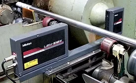 Laser scan micrometer measuring diameter immediately after finish grind operation.