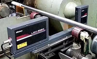 Laser scan micrometer measuring diameter immediately after finish grind operation.