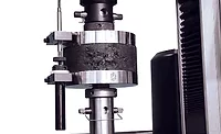 Compression testing on a cylindrical specimen. Compression testing on a cylindrical specimen.