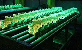 Aerospace parts undergoing fluorescent penetrant testing.