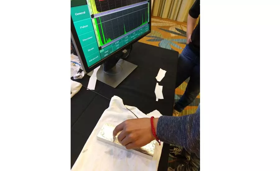 A student detecting a defect with ultrasonic testing.