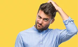 man scratching his head
