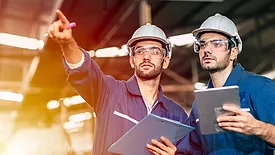 01 QM 1223 Management feature opening image of two quality personnel in hard hats