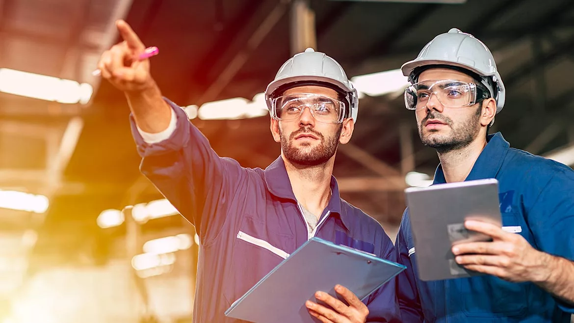 01 QM 1223 Management feature opening image of two quality personnel in hard hats