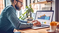 QM 1223 Software and Analysis QMS Software Trends man using laptop