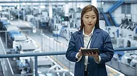 Engineer Monitoring and Analyzing Conditions at a Modern Electronics Factory Engineer Monitoring and Analyzing Conditions at a Modern Electronics Factory with Automated Robot Hands Working with the Help of Artificial Intelligence Software.