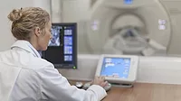 Medical personnel operating CT scanner in hospital Medical personnel operating CT scanner in hospital.