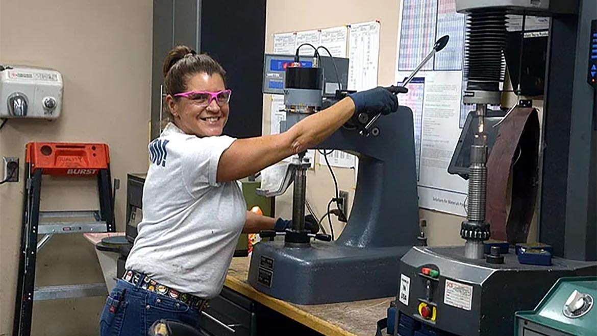 Quality Leadership rankings. At number 5, Pinson Valley Heat Treating. Female employee Rockwell testing.