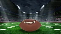 Unraveling Deflategate: Football stadium with closeup of football on field Unraveling Deflategate: Football stadium with closeup of football on field