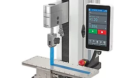 F305 EM G1109: A UTM configured for a 90-degree peel test of tape adhesive according to ASTM D3330. 