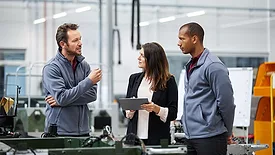QM 0124 Quality 101 feature opening image Automobile engineer discussing with colleagues in car factory