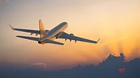Airplane flying above clouds during sunset Airplane flying above clouds during sunset