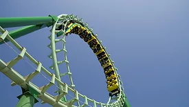 Roller coaster looping the loop at amusement park.