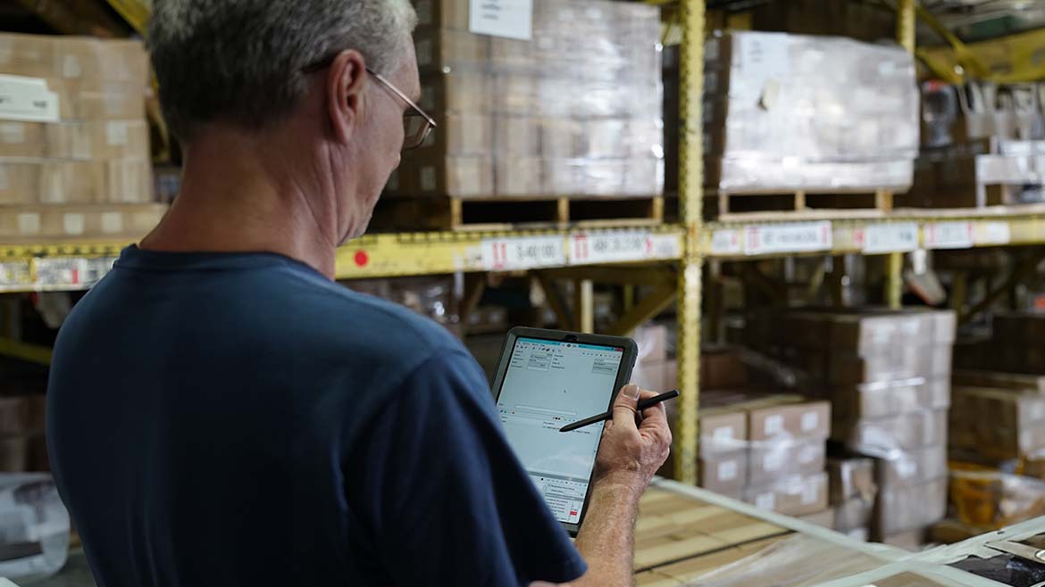 PAC Strapping Products worker using ERP on a tablet