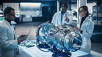 Airplane Engine Engineer and Scientist Work on a Futuristic Turbine Motor, Standing with Tablet Computer in Scientific Technology Lab.