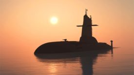 Surfaced submarine in the water at sunset